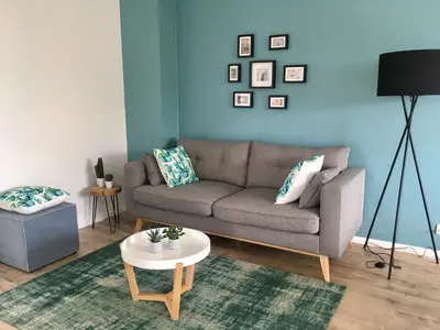 a living room with a couch and a table at L'Inizio Suite in Herve
