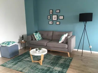 a living room with a couch and a table at L'Inizio Suite in Herve
