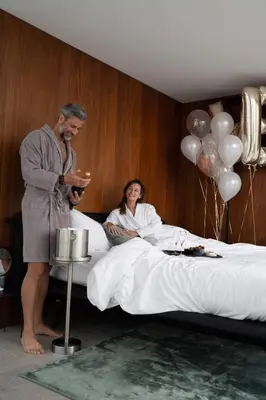 a man standing next to a woman in a bed at HasHotel in Hasselt