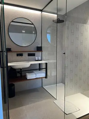 a bathroom with a sink and a mirror at HasHotel in Hasselt