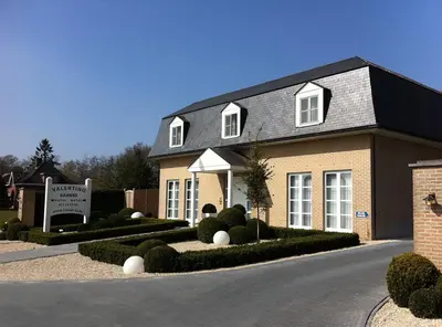 a brick house with a sign in front of it at Villa Valentino in Hasselt