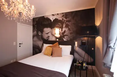 a bedroom with a bed with a large painting on the wall at Villa Valentino in Hasselt