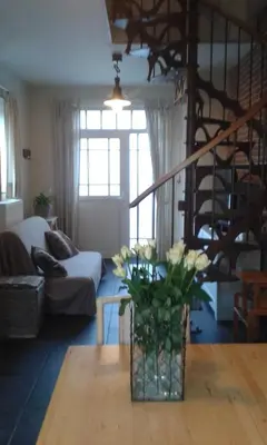 a living room with a vase of flowers on a table at Vakantiewoning Tivoli in Dilsen-Stokkem
