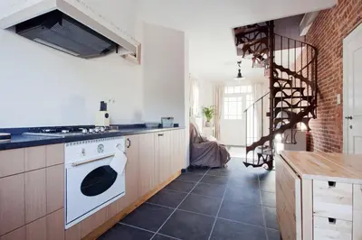 a kitchen with a stove and a white oven at Vakantiewoning Tivoli in Dilsen-Stokkem