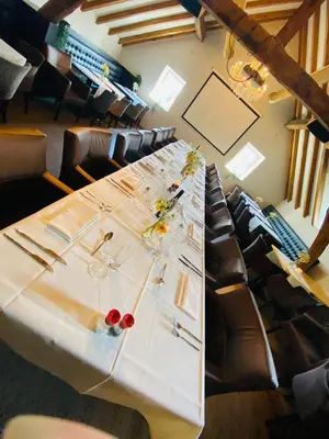 a long table in a room with chairs at Hotel De Boskar Peer in Peer