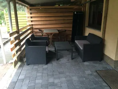 a patio with two chairs and a table and a table at de bron in Beringen