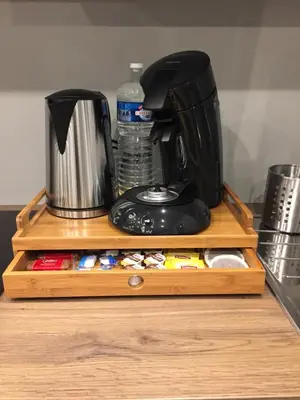 a coffee maker sitting on top of a wooden shelf at Rentalis Flat in Liège