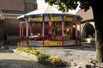 a carousel in front of a building at twee broeders in Riemst