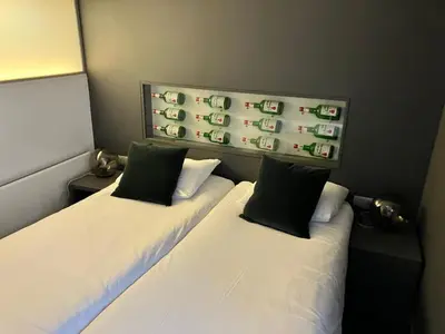 two beds in a small room with at Hotel De Groene Hendrickx in Hasselt