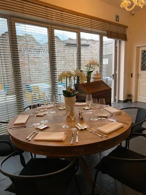 a table with glasses and napkins on top of it at Kirisavan Bed&Breakfast in Borgloon