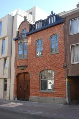 a red brick building on a city street at Hollandia City Distillery in Hasselt