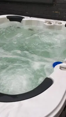 a hot tub with green water in it at Hollandia City Distillery in Hasselt