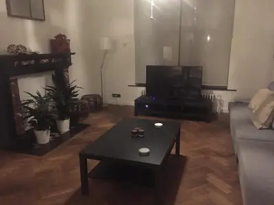 a living room with a couch and a coffee table at Hollandia City Distillery in Hasselt