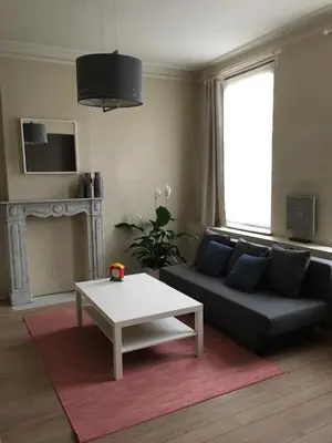 a living room with a couch and a coffee table at Hollandia City Distillery in Hasselt