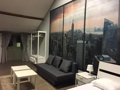 a living room with a large mural of a city at Hollandia City Distillery in Hasselt