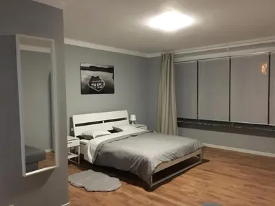a bedroom with a large bed and a window at Hollandia City House in Hasselt