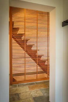 a room with a large window with wooden blinds at De Oude Katsei in Gingelom