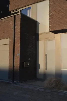 a brick building with two garage doors on it at Appartroom Hasselt in Hasselt