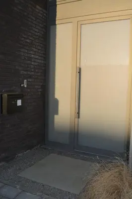 a door to a building with a brick wall at Appartroom Hasselt in Hasselt