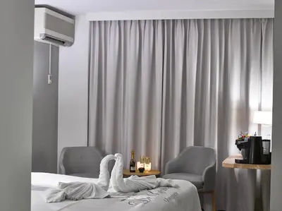a hotel room with a bed and two chairs at Hotel Restaurant De Kommel in Voeren