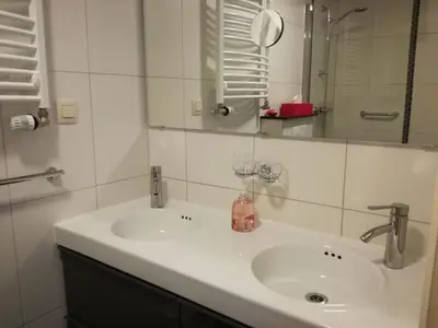 a bathroom with a white sink and a mirror at La Rose in Overpelt