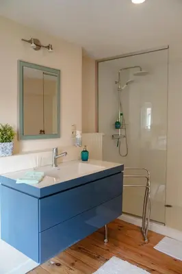 a bathroom with a sink and a shower at De Koetsier in Lanaken