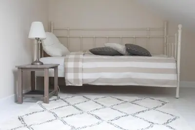 a bedroom with a bed with a table and a lamp at De Koetsier in Lanaken