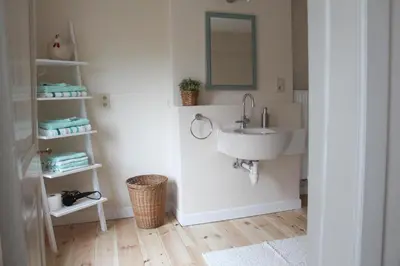 a bathroom with a sink and a mirror at De Koetsier in Lanaken