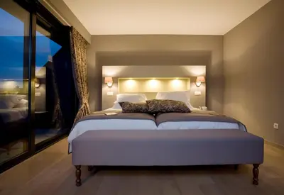 a bedroom with a large bed with two pillows on it at Tuinhotel in Lommel