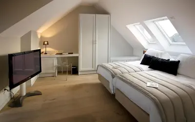 a bedroom with a bed and a flat screen tv at Tuinhotel in Lommel