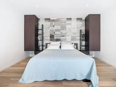 a bedroom with a large bed with wooden cabinets at Les Begards Espace 9 in Chaudfontaine
