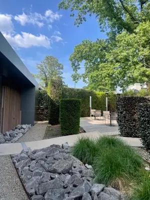 a garden with rocks and a house at Les Begards Espace 9 in Chaudfontaine