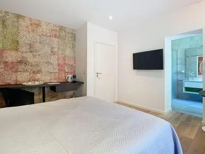 a bedroom with a white bed and a window at Les Begards Espace 9 in Chaudfontaine