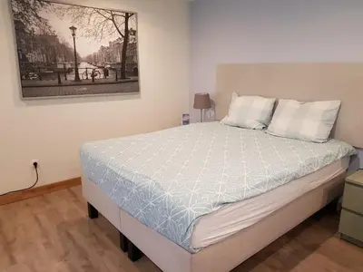 a bed in a bedroom with a picture on the wall at Logie Rotem in Dilsen-Stokkem