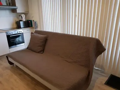 a couch with a pillow on it in a kitchen at Logie Rotem in Dilsen-Stokkem