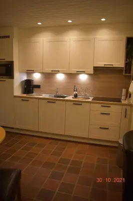 a kitchen with white cabinets and a sink at Hengelhoef vakantieverblijf DEN 5 in Houthalen-Helchteren