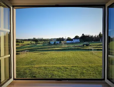 a window view of a field from a house at Villa&Loge in Lontzen