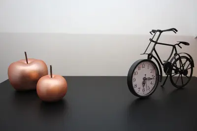 two apples and a clock and a bike on a table at Villa&Loge in Lontzen