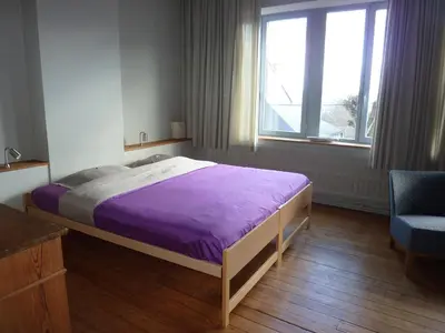 a bedroom with a purple bed and a window at W'allons nous dormir in Liège