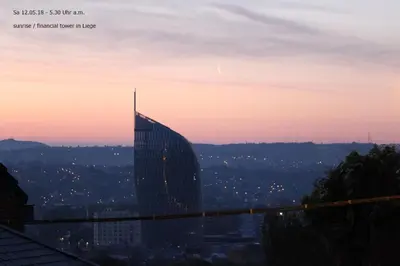 a view of a skyscraper in a city at sunset at W'allons nous dormir in Liège