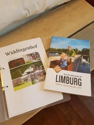 two brochures sitting on top of a table at Widdingenhof in Wellen
