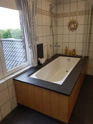 a bath tub in a bathroom with a window at Widdingenhof in Wellen