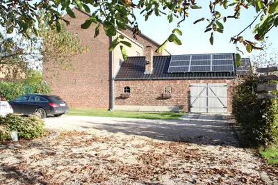 a house with a garage with a solar roof at Widdingenhof in Wellen