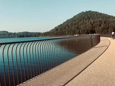 a metal fence next to a body of water at Hotel Au Nom De Dieu in Dilsen-Stokkem