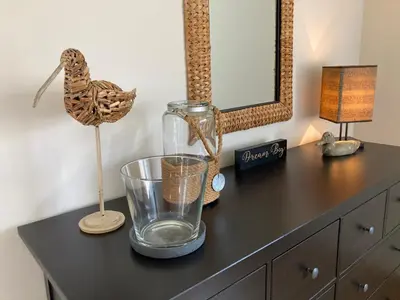 a black dresser with a glass vase and a mirror at 'tMaelhof in Voeren