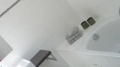 a white bathroom with a tub and a sink at 'tMaelhof in Voeren