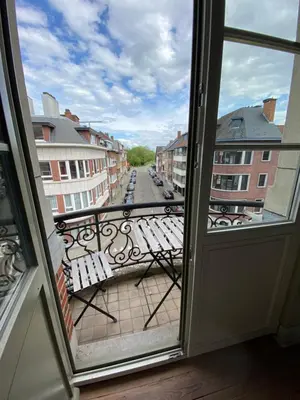 an open door to a balcony with a view of a street at Hasselt City Garden Duplex in Hasselt