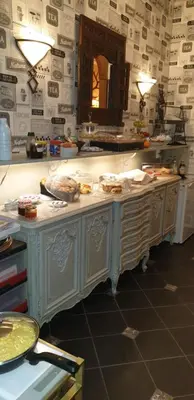 a kitchen with a table with food on it at Hotel Des Ardennes in Verviers