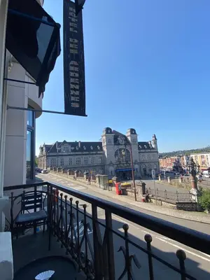 a view of a street from a balcony of a building at Hotel Des Ardennes in Verviers