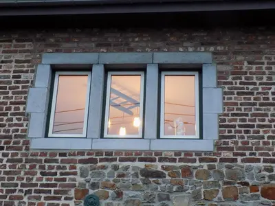 a window on the side of a brick building at (La parenthese) in Hombourg